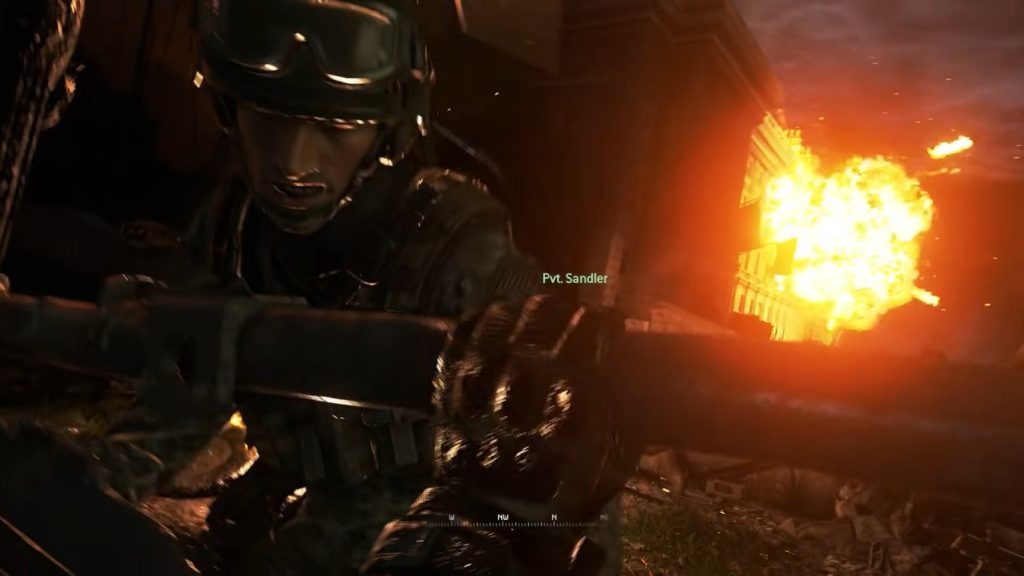 A soldier helps Ramirez who is stuck in a chopper while an explosion happens in the background