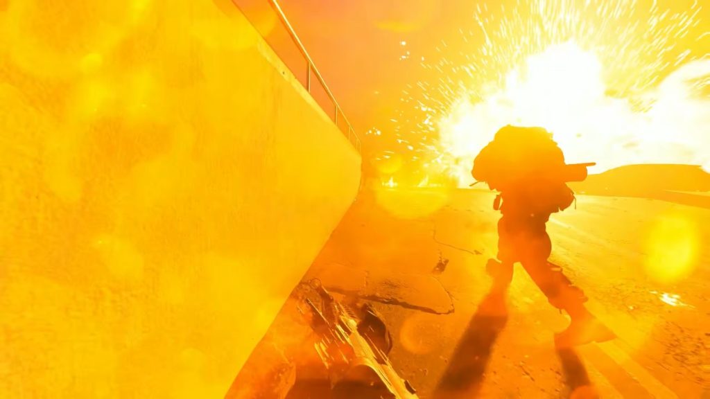 A soldier running while a large explosion lights the entire area