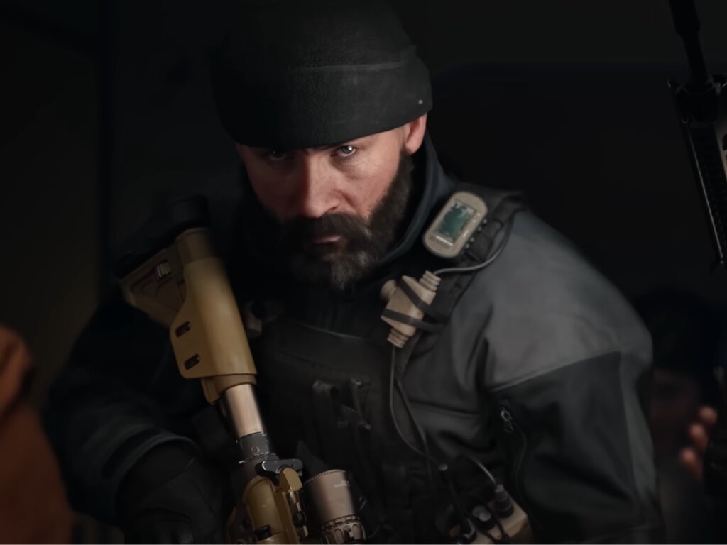 Captain Price in beard and holding a gun with mouth down