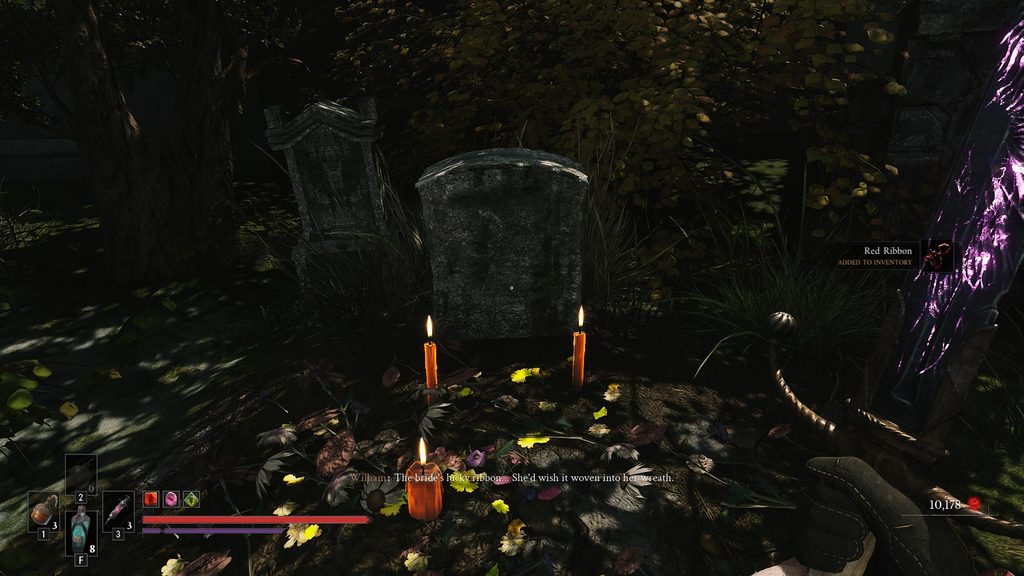 Valor Mortis grave with a red ribbon on it.
