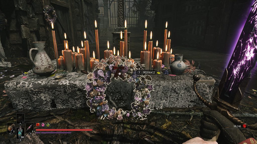 Valor Mortis grown wreath with a red ribbon on it.